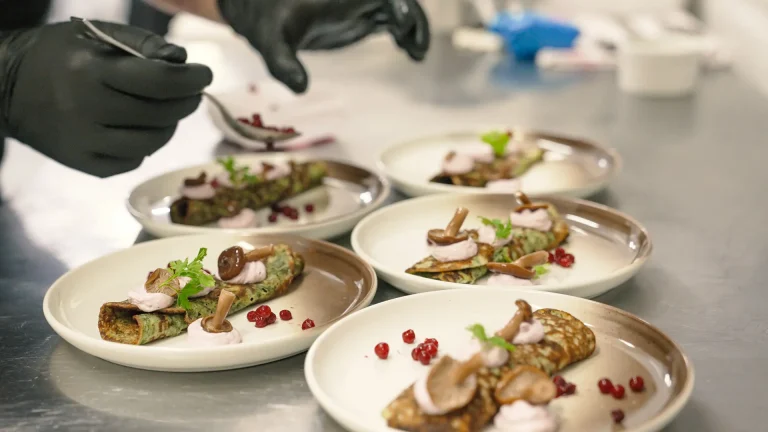 A close up of a chef preparing appetizers in the kitchen of The Northern Lights Ranch restaurant.